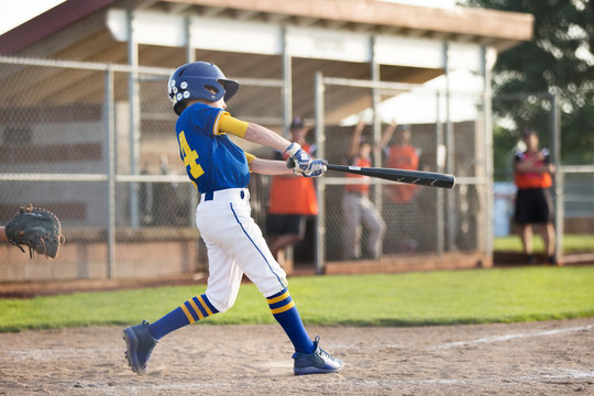 A child swinging a baseball bat AI-generated content may be incorrect.